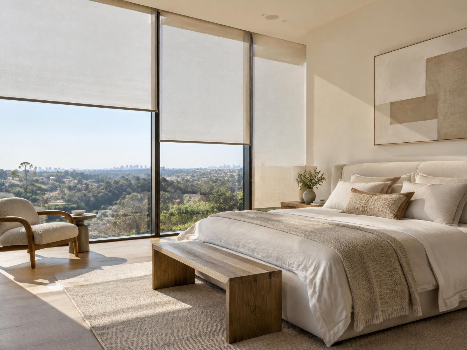 Motorized roller shades set at different heights across bedroom windows in midday sun